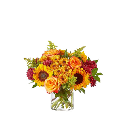 Sunflowers and roses in a clear low vase