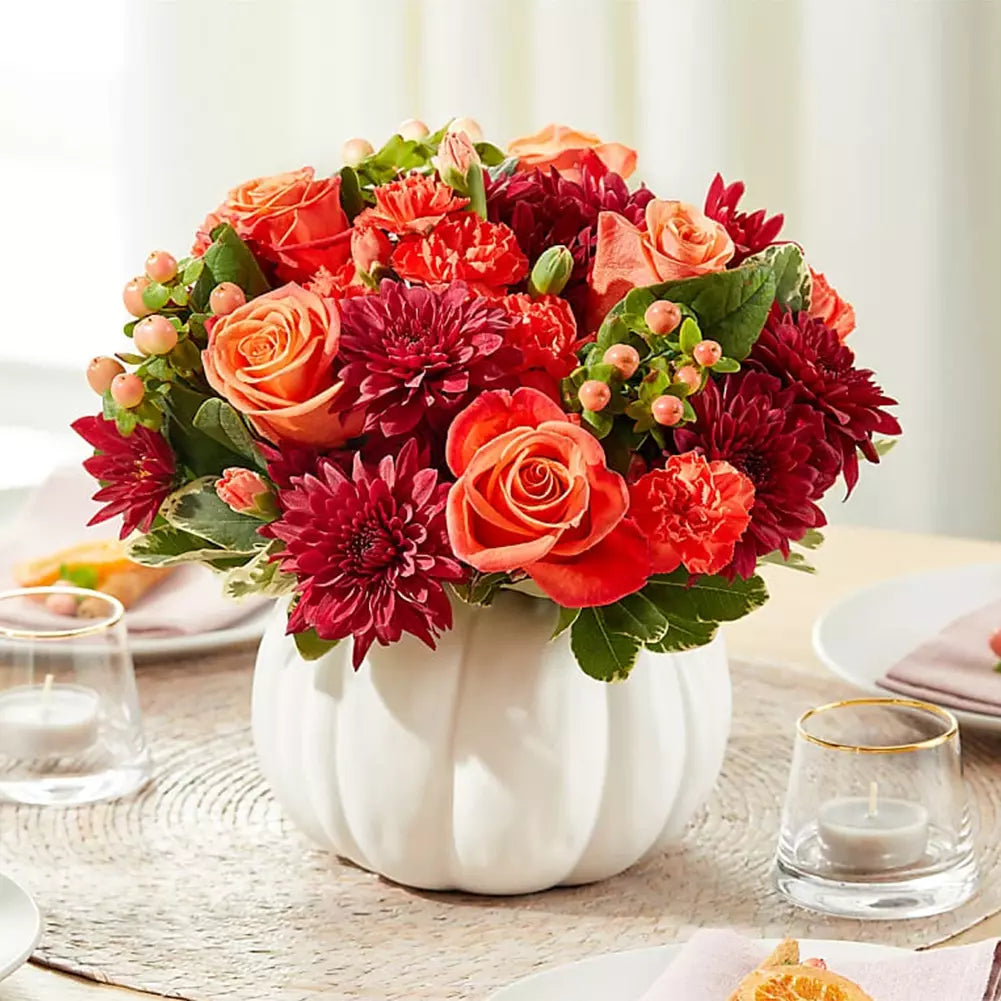 Roses and carnations in white pumpkin base