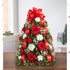 Árbol de Flores Navideñas Medium. ¡El tradicional árbol favorito de las fiestas en donde empezó todo! Nuestro arreglo de árbol de flores es popular por su estética festiva y su tamaño compacto, que se adapta a cualquier entorno. Detalles del arreglo: Rosas Rojas y mini Claveles; Cojines blancos; Acentuado con baby’s breath, vegetación navideña variada, adornos y un lazo rojo en la parte superior. Domicilio Gratis Orlando FL, Fresh Flowers Orlando.