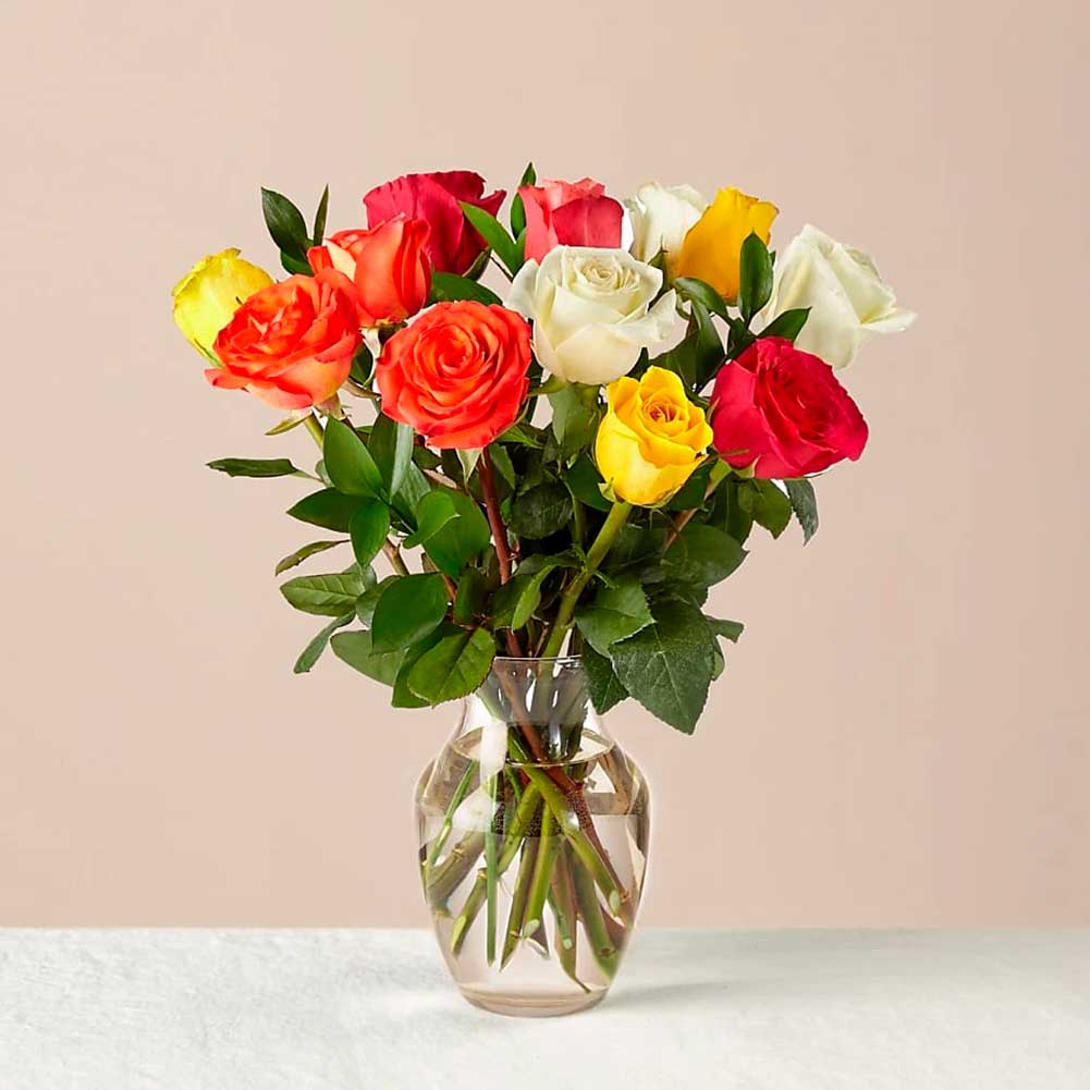 Mixed Roses with Vase. Colorful and blooming, this vibrant bouquet of a dozen roses is an instant mood booster. Fresh Flowers Orlando.